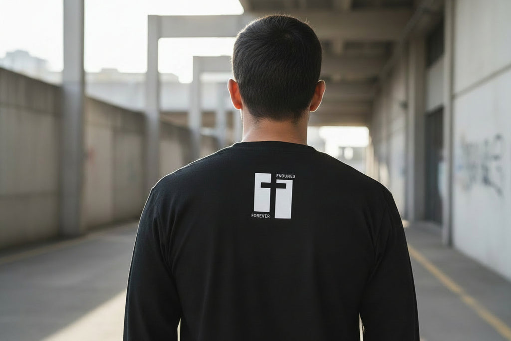 Black long-sleeve shirt with a white logo on the back against a white background