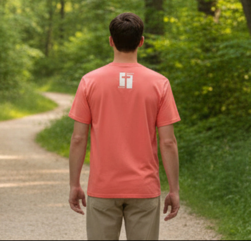 Coral t-shirt with a logo on the back against a gray background