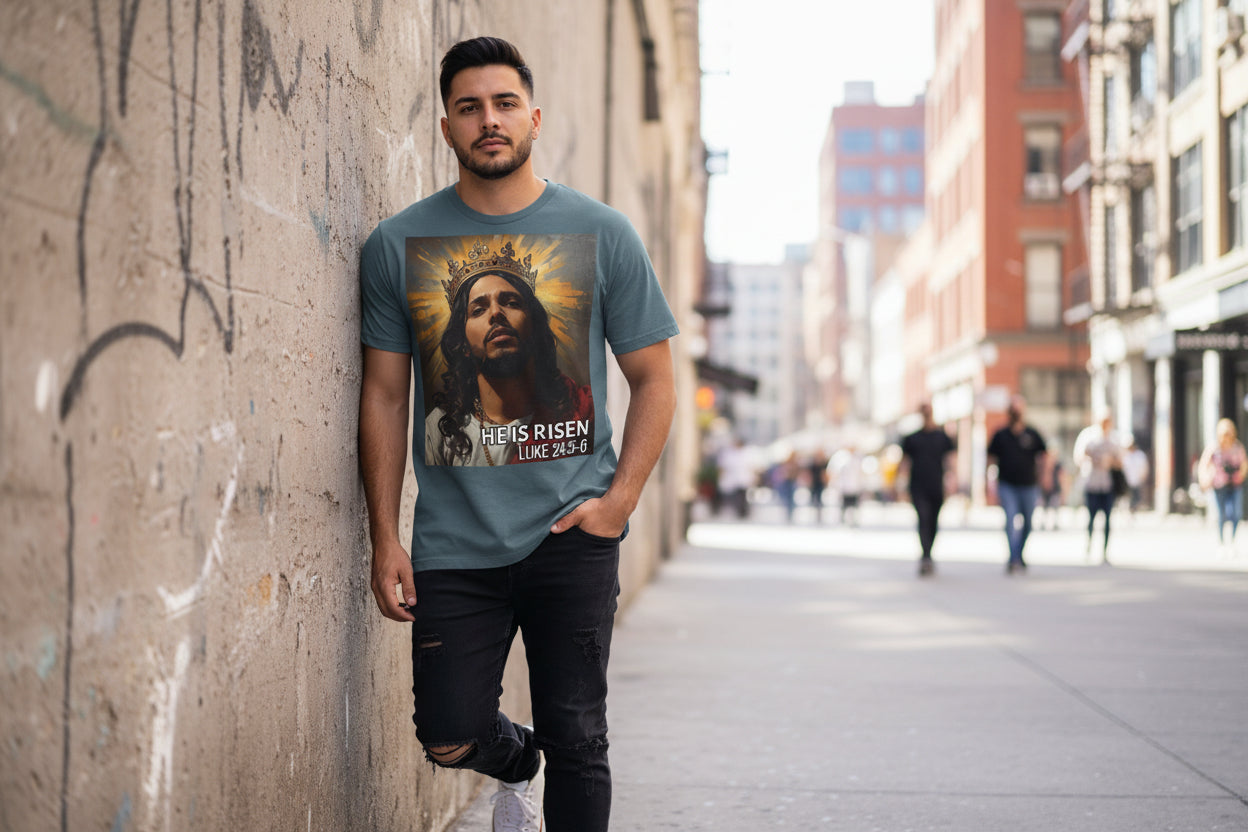 Deep Teal Blue t-shirt with a graphic of a crowned fHispanic Jesus and 'He is Risen' text on a white background