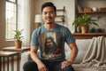 Blue t-shirt with a graphic of an Asian Jesus wearing a crown and 'He is Risen' text on a white background