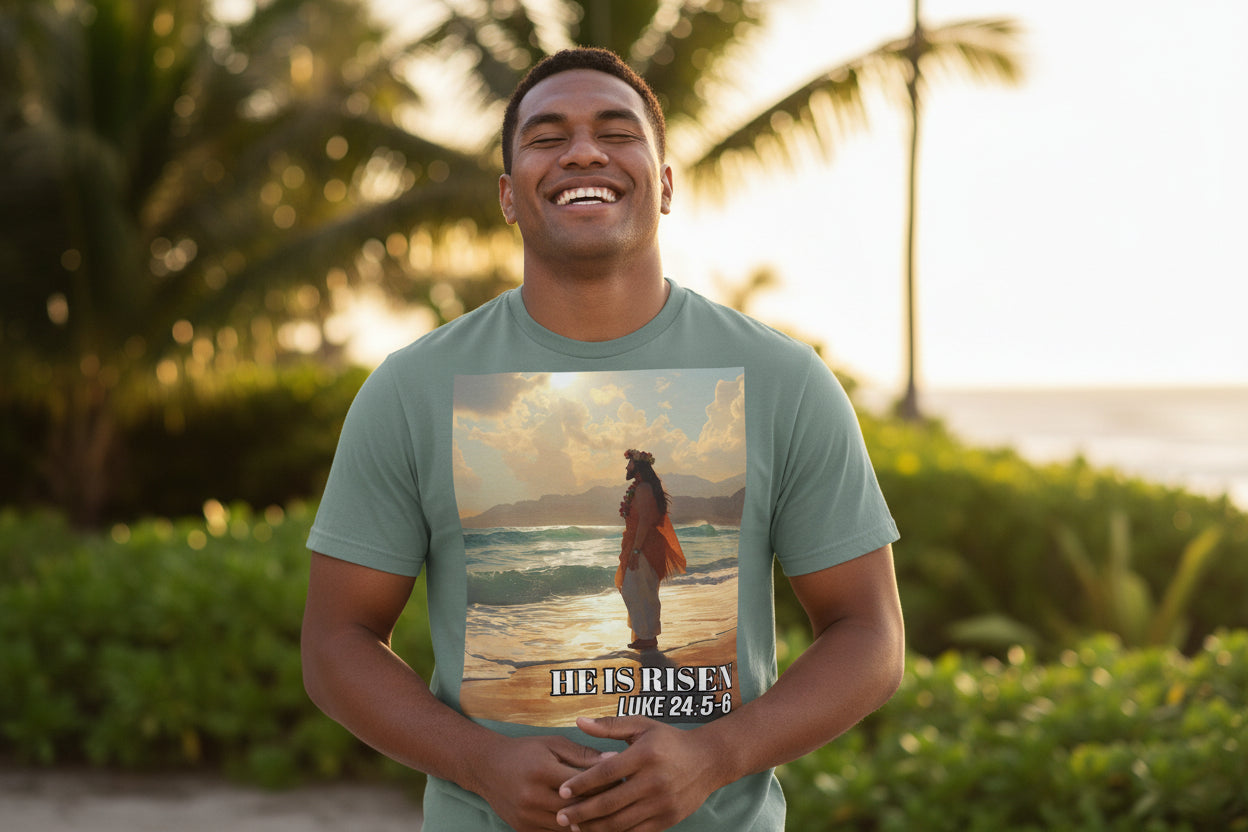 Man wearing a t-shirt with a beach scene of a Pacific Island Jesus and 'He is Risen' text on a beach.