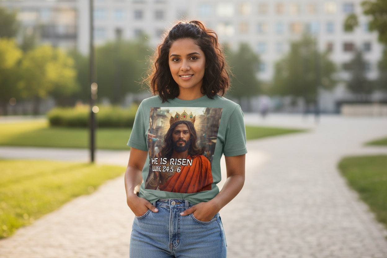 T-shirt with a graphic of an Indian Jesus in a crown and robe, with 'He is Risen' text on a light green background