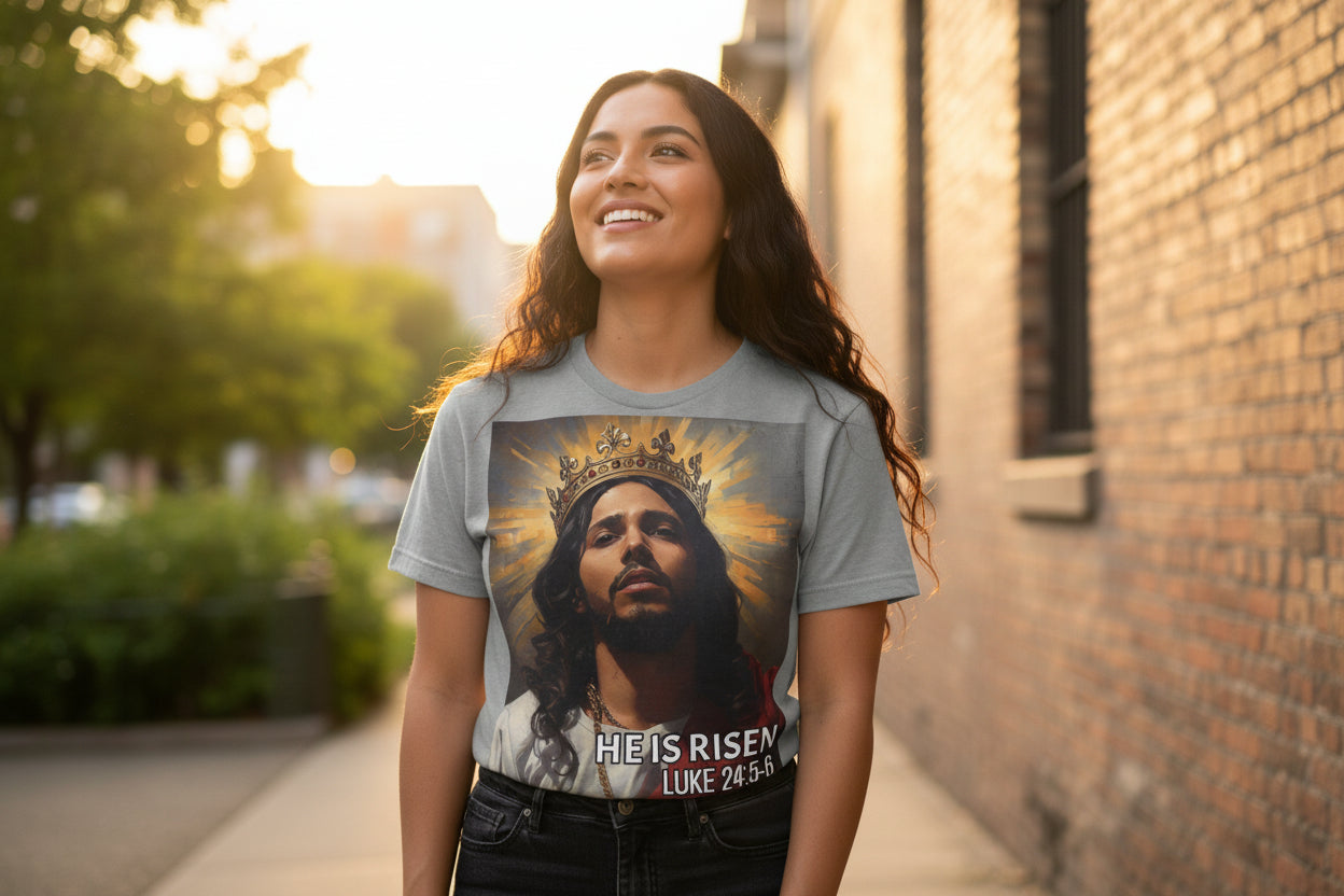 Gray t-shirt with a graphic of a crowned Hispanic Jesus and 'He is Risen' text on a white background