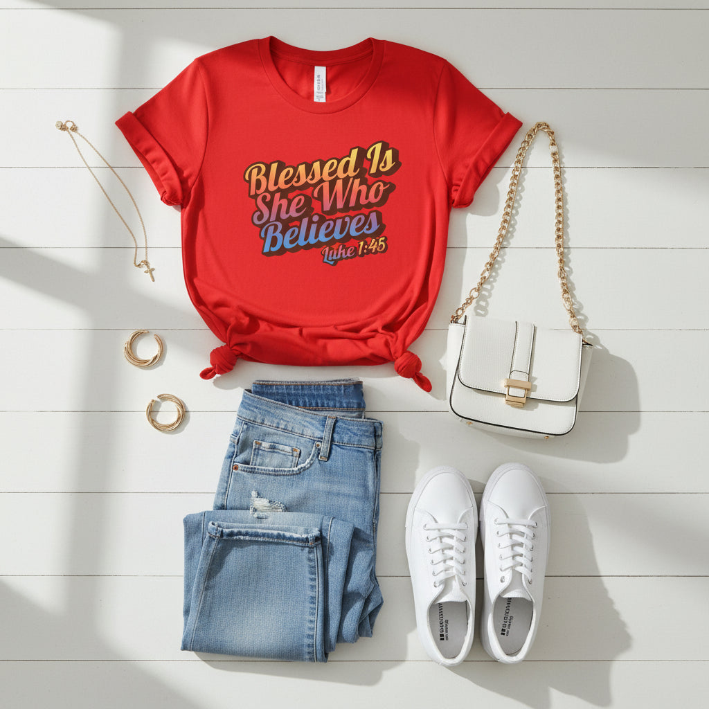 Red t-shirt with 'Blessed Is She Who Believes Luke 1:45' text on a white background