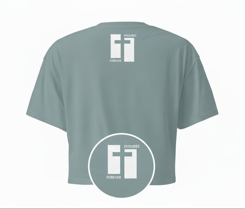 Mineral green cropped t-shirt with a cross logo with text "Endures Forever" on the back against a white background